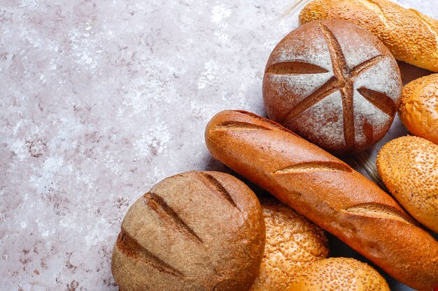 Diversi tipi di pane fresco come sfondo, vista dall'alto