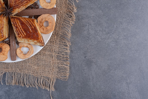 Dolci fatti in casa e frutta secca sul piatto bianco.