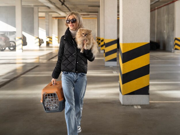 Donna a tutto campo che tiene un cane carino