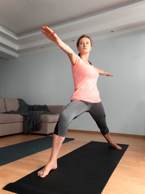 Donna a tutto campo con tappetino da yoga