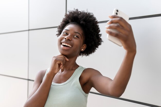 Donna afroamericana che si fa un selfie con il suo smartphone