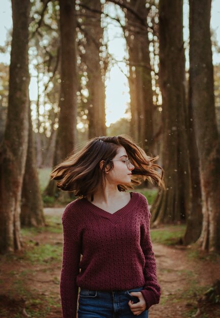 Donna agitando i capelli nella foresta