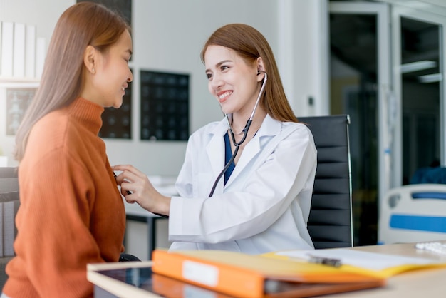 Donna asiatica medico Cancro al seno Sintomi fattori di rischio e controllo del trattamento per il paziente nell'ufficio della clinica