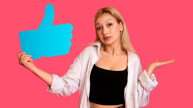 Donna che mostra banner che sembra felice eccitato su sfondo rosa