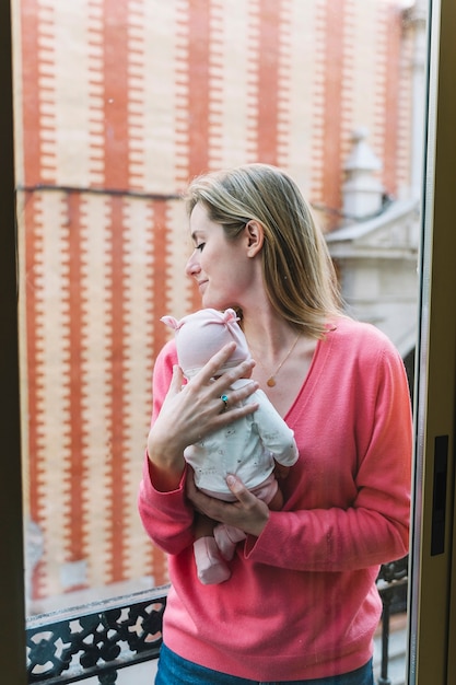 Donna che tiene bambino sul balcone