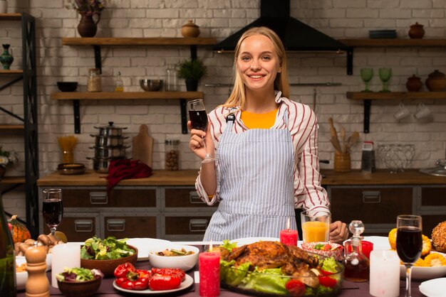 Donna che tiene un bicchiere di vino rosso e sorriso