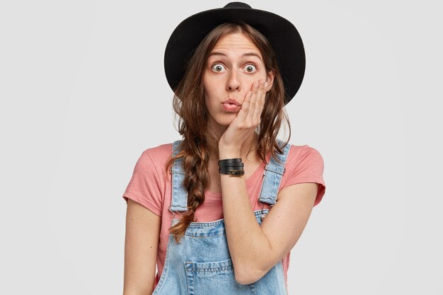 Donna con elegante cappello nero e tuta