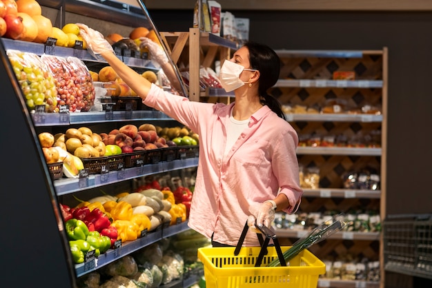 Donna del colpo medio che compra frutta