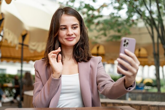 Donna del colpo medio che prende selfie