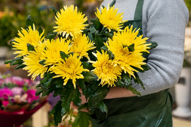 Donna del primo piano che tiene i fiori eleganti