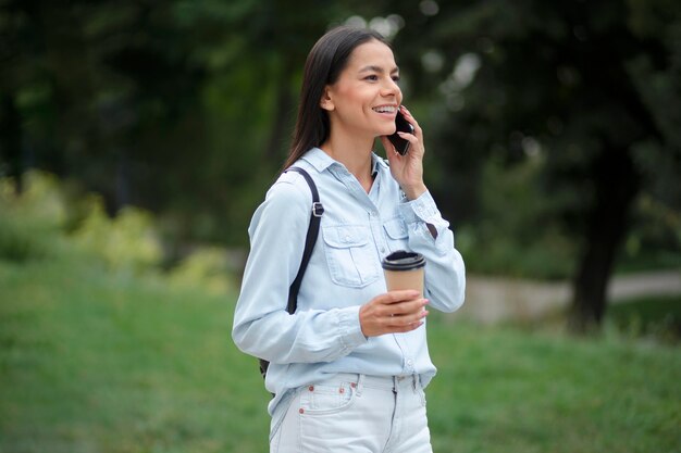 Donna del tiro medio che parla al telefono