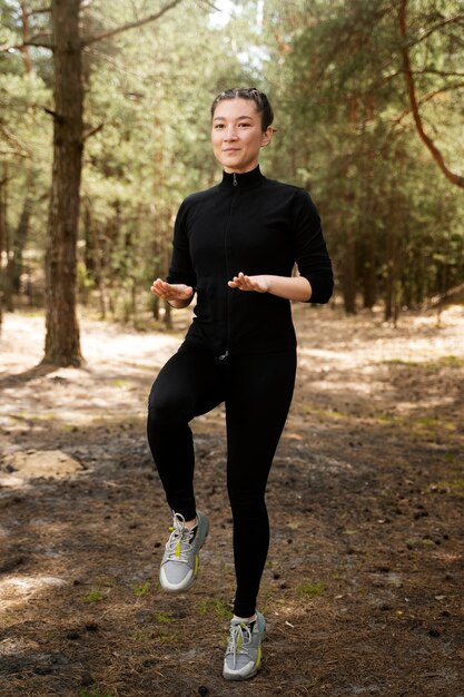 Donna della foto a figura intera che fa sport all'aperto