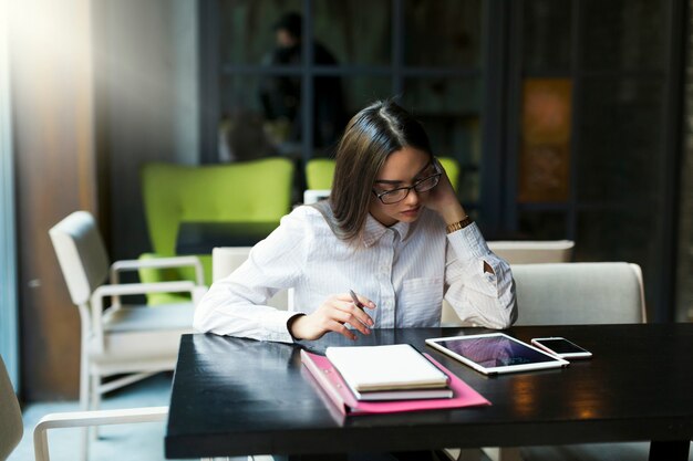 Donna di affari premurosa che si siede nel caffè