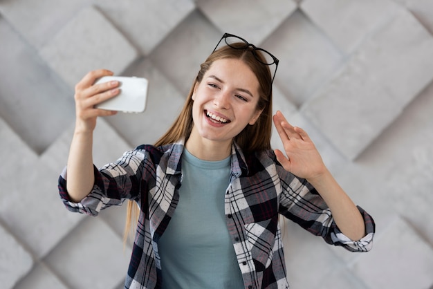 Donna di smiley che prende un selfie con il suo telefono