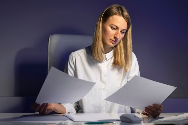 Donna di tiro medio che lavora a tarda notte