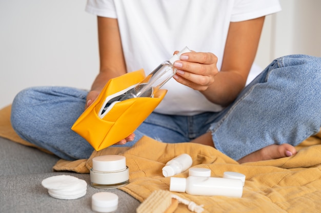 Donna di vista frontale che utilizza la borsa da toilette