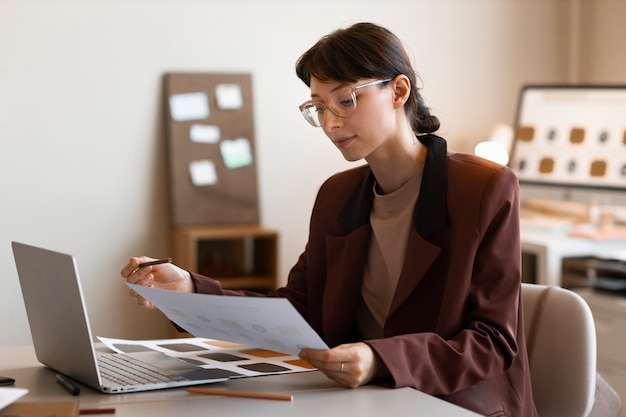 Donna di vista laterale che lavora allo scrittorio