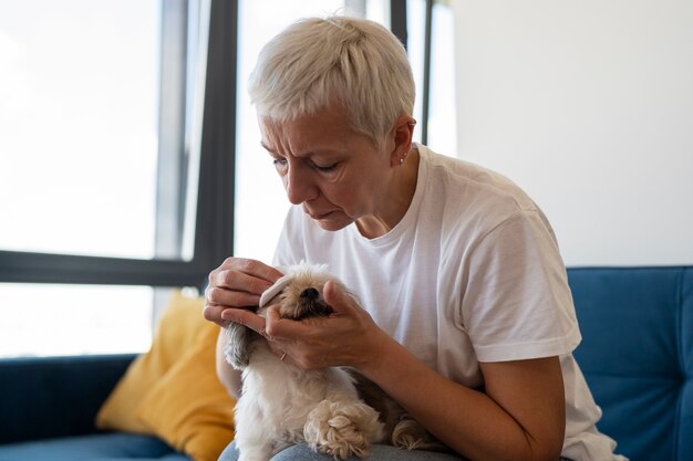 Donna di vista laterale che tiene cane sveglio