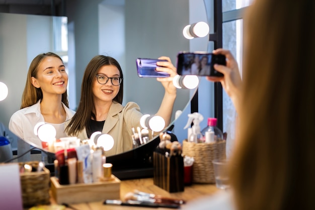 Donna e truccatore che prendono un selfie