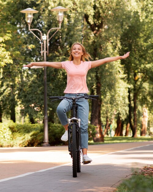 Donna in sella a una bicicletta senza tenerla