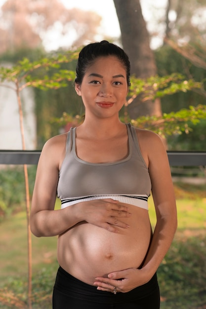 Donna incinta vestita con abbigliamento sportivo