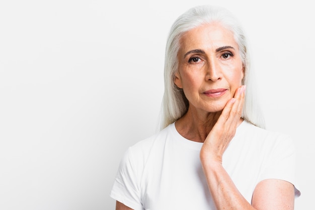 Donna senior di vista frontale che esamina macchina fotografica