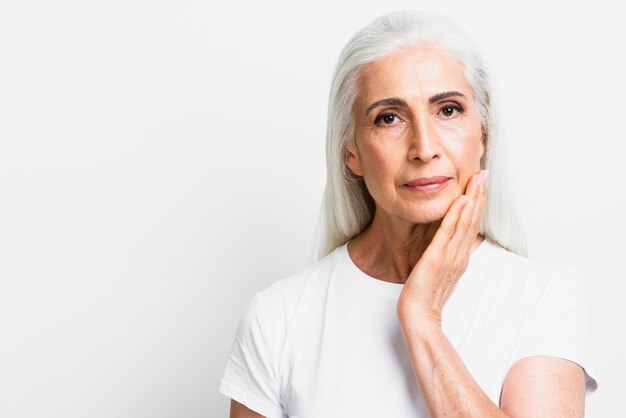 Donna senior di vista frontale che esamina macchina fotografica