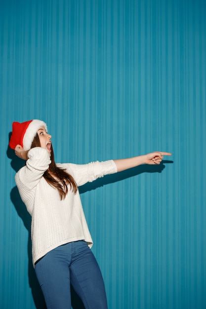 Donna sorpresa di natale che porta un cappello di Santa