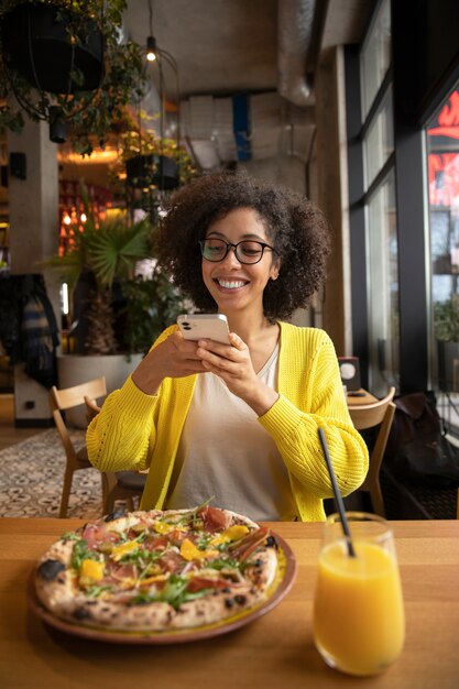 Donna sorridente con piano medio e pizza