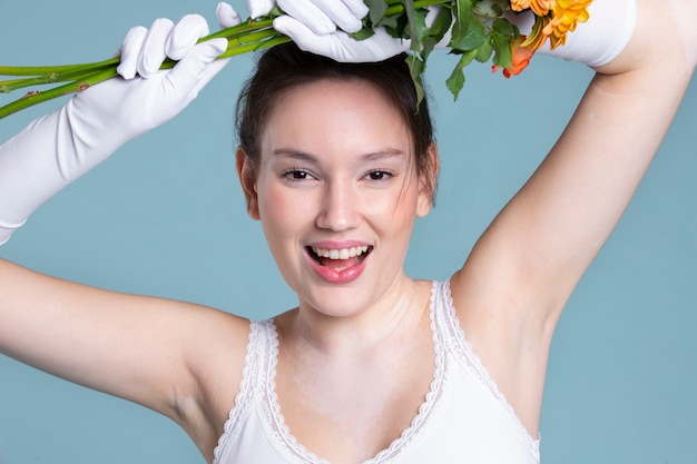 Donna sorridente del colpo medio con guanti e fiori