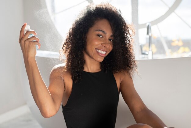 Donna sorridente di colpo medio con capelli afro