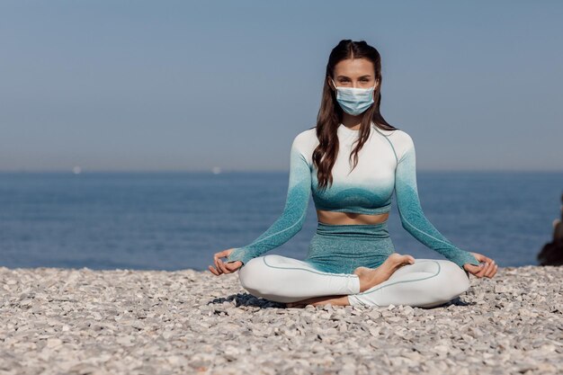 donna yoga all'aperto vicino al mare