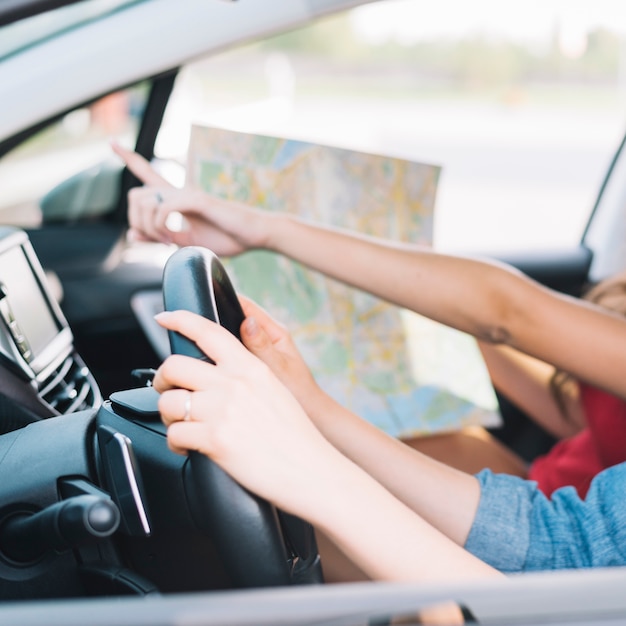 Donne che guidano auto con mappa