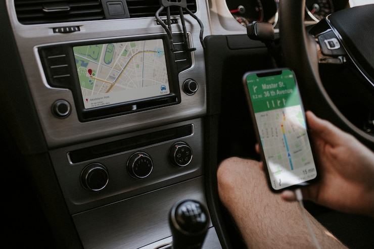 Foto gratuito driver che utilizza il telefono cellulare per la navigazione