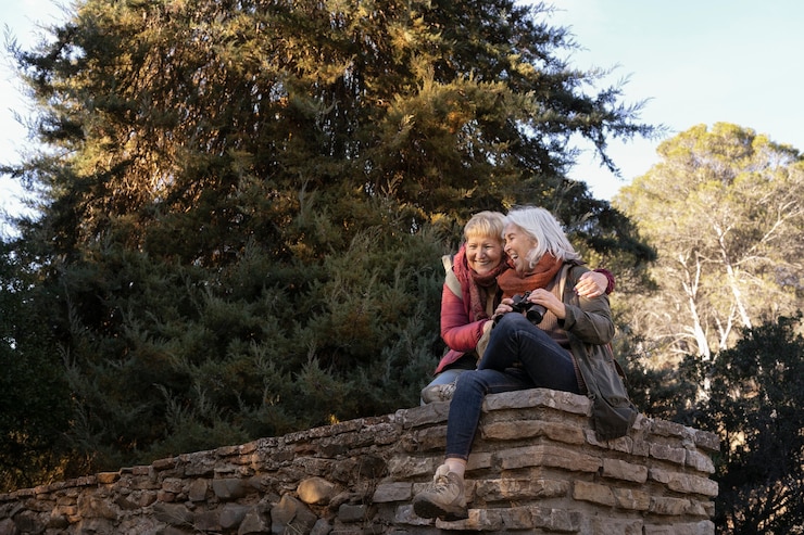 Foto gratuito due donne anziane che si godono un'escursione nella natura mentre usano il binocolo