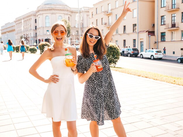 Due giovani belle ragazze sorridenti hipster in abiti estivi alla moda