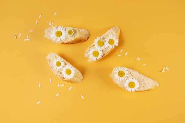 Elegante concetto di cibo ecologico con fiori sul pane