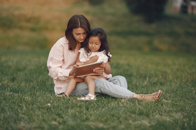 Elegante madre con figlia in un parco estivo