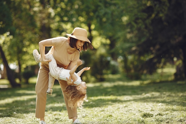 Elegante madre con figlia in una foresta estiva