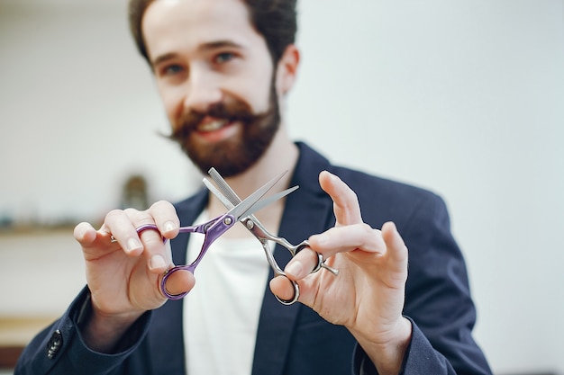 Elegante uomo in piedi in un negozio di barbiere