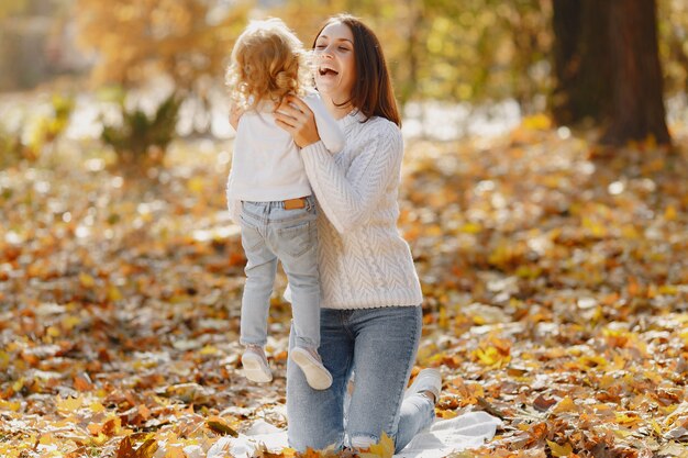 Famiglia carina ed elegante in un parco in autunno