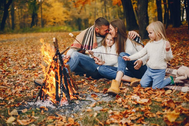 Famiglia con bambini carini in un parco in autunno