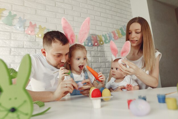 Famiglia con due bambini in una cucina che prepara a pasqua