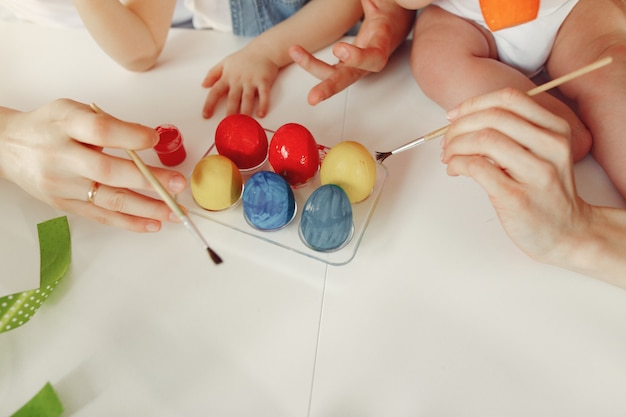 Famiglia con due bambini in una cucina che prepara a pasqua