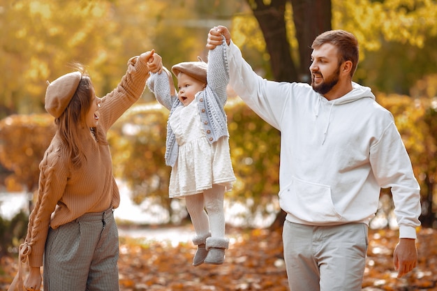 Famiglia con la piccola figlia in un parco di autunno