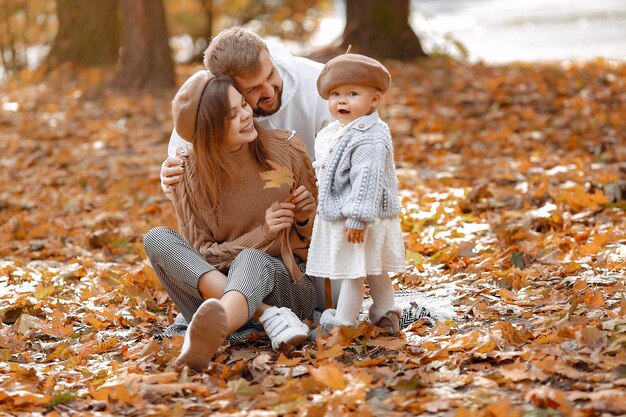 Famiglia con la piccola figlia in un parco di autunno