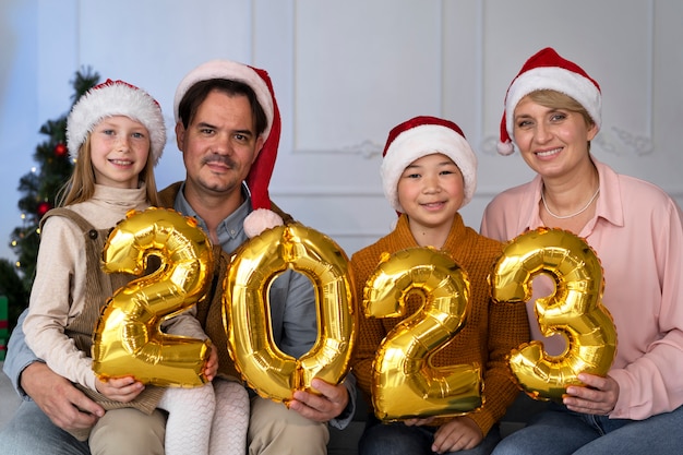 Famiglia di quattro persone che festeggiano il capodanno a casa insieme