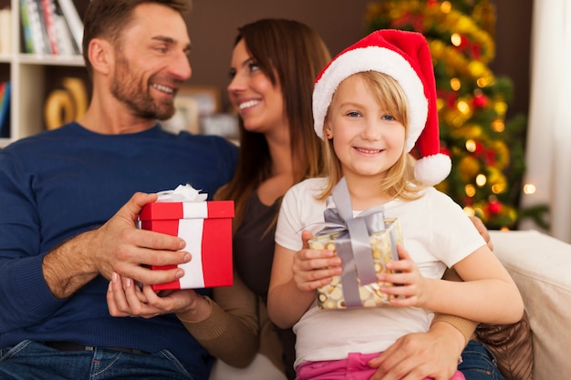 Famiglia felice che scambia i regali di Natale