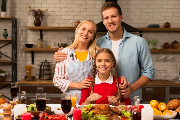 Famiglia felice che sorride e che esamina la macchina fotografica