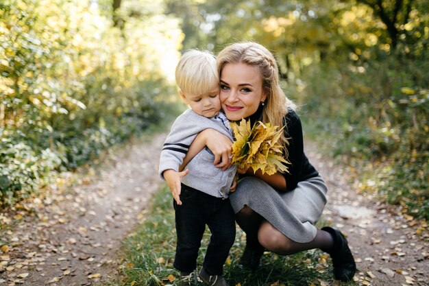 famiglia felice giocando e ridendo nel parco in autunno